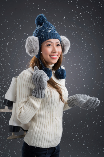 Young woman going to skate in snow