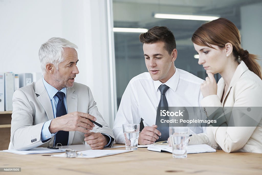 Making sure everyone is on the same page Shot of corporate business people discussing what will happen in their company Adult Stock Photo