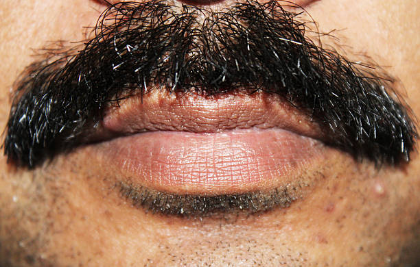 istock Closeup of men's lips under black mustache 466549272