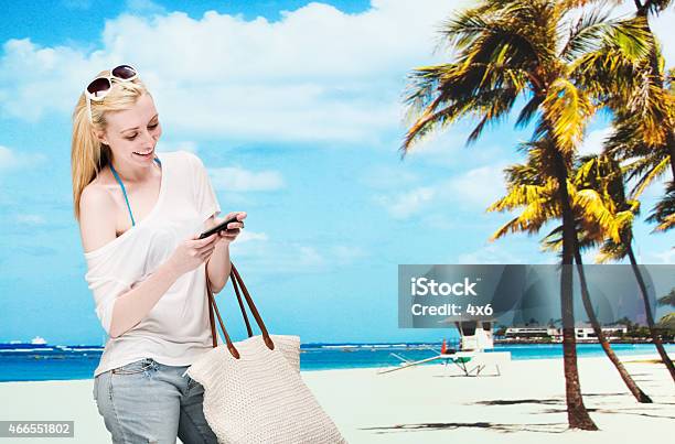 Smiling Female Using Mobile In Front Of Beach Stock Photo - Download Image Now - 20-29 Years, 2015, Adult