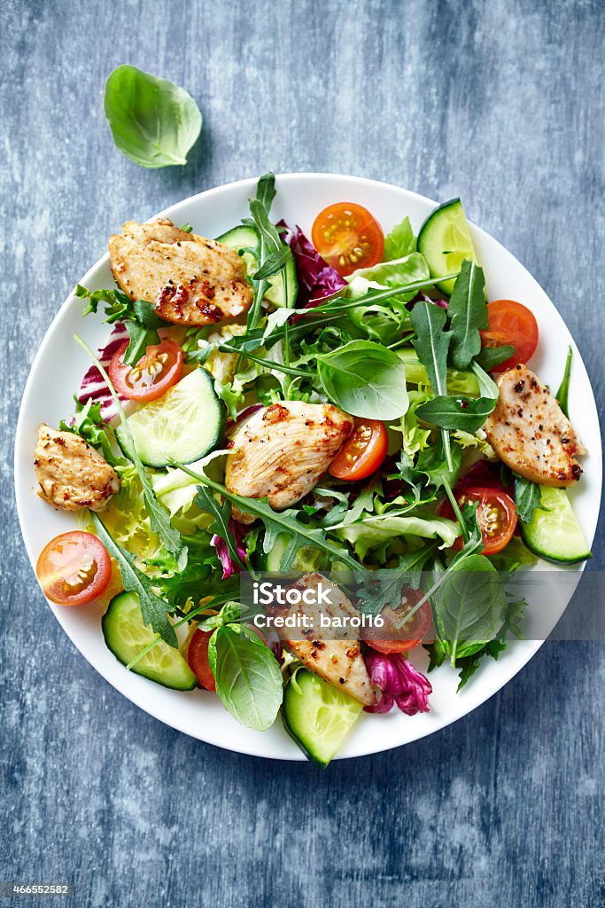Chicken salad with leaf vegetables and cherry tomatoes Chicken Salad Stock Photo