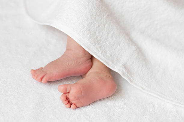 istock Baby feet in a white towel 466555263