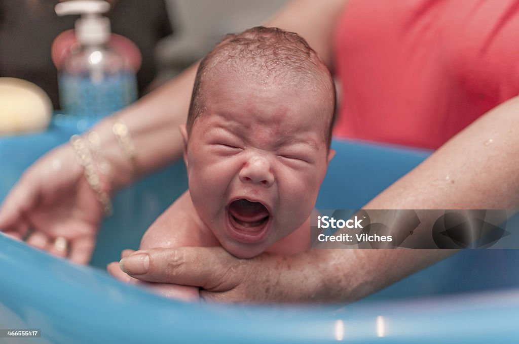 Wailing baby Baby screaming out of the top of his lungs when getting a bath. Baby Bathtub Stock Photo