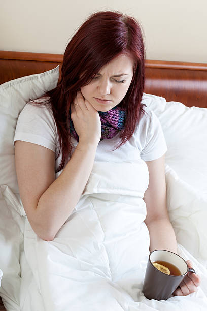 istock Woman with throat infection 466556037