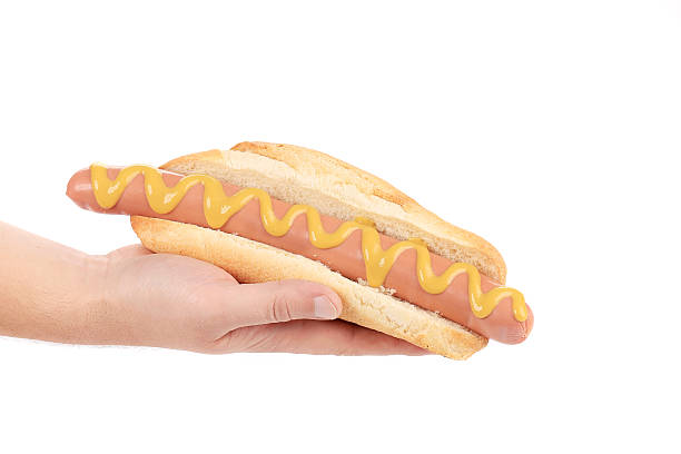 istock Hotdog with mustard in hand. 466557349
