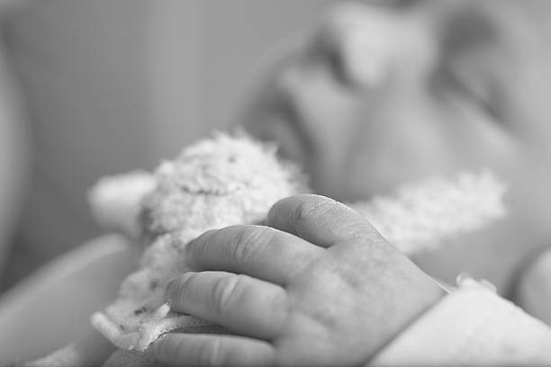 istock Baby hold a cuddly toy 466559113