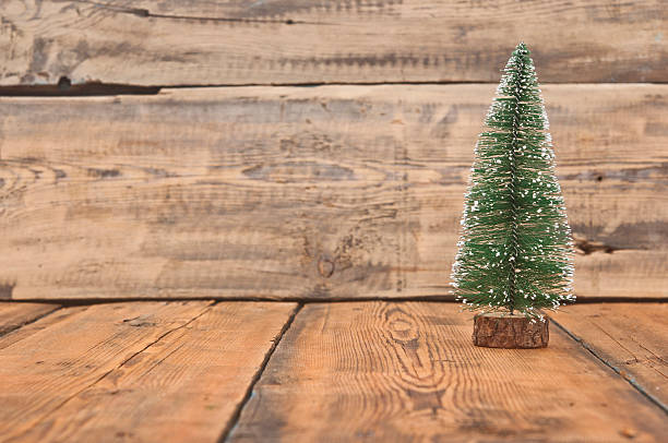 istock Little toy christmas tree on old wooden table 466561931