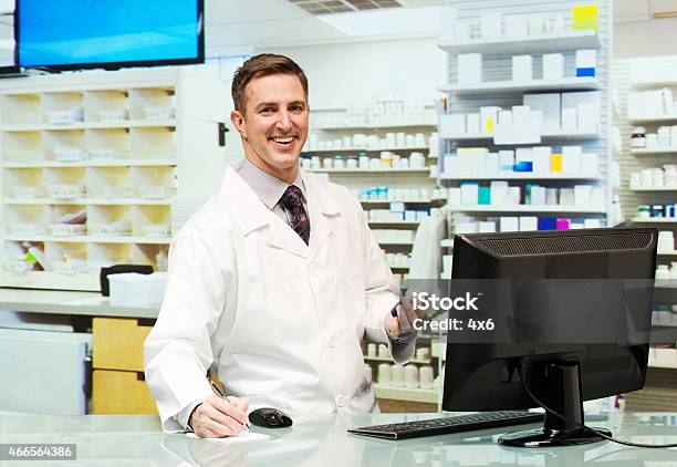 Smiling Pharmacist Working In Drug Store Stock Photo - Download Image Now - 2015, 30-39 Years, 35-39 Years