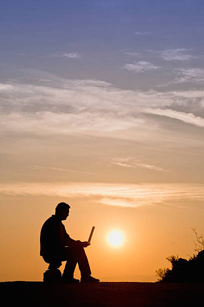 istock Silhouette of businessman working with laptop 466566719