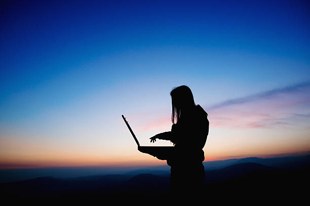 istock Girl working with laptop at sunset 466566833