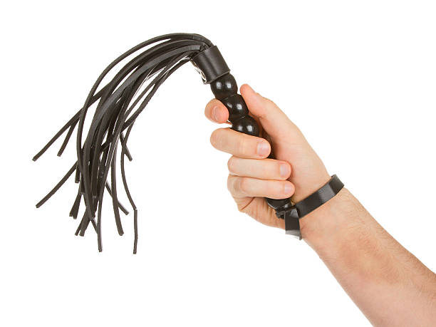 istock Strict Black Leather Flogging Whip in man's hand 466567143