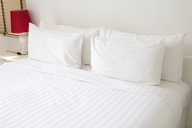 istock White sheets and pillows on a bed in a modern bedroom 466570420