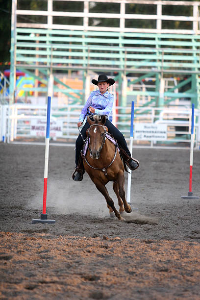 istock Cowgirl Running Poles at Rodeo 466572575