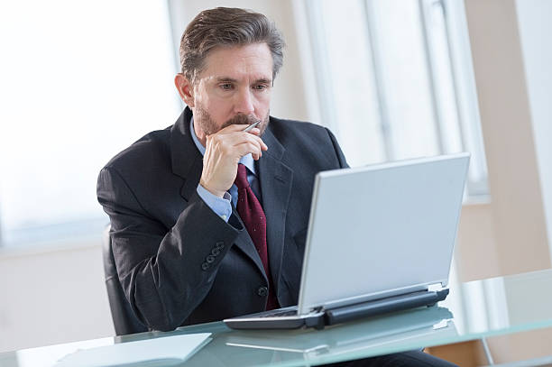 istock Businessman Using Laptop At Desk 466573383