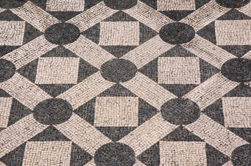 Typical old Portuguese black and white stone mosaic \