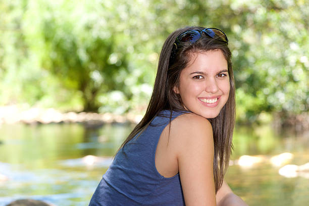 istock Friendly young woman smiling outdoors 466578364