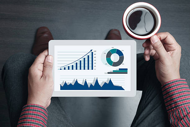 istock Businessman holding tea with business graph on digital tablet 466581058