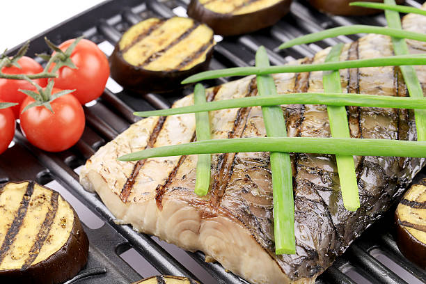 istock Grilled carp fillet on grill with egg plant. 466582273