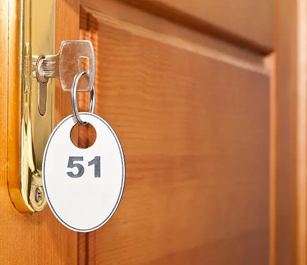 Close up of hotel key in door-handle lock
