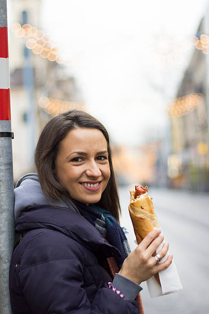 istock girl eating hotdog 466583423