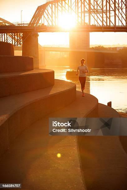 A Woman Running Along The Ohio River During Sunrise Stock Photo - Download Image Now