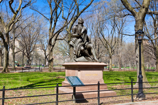 New York, NY, USA - April 2, 2010: Central Park in early spring. The image shows a sculpture of a Scottish poet and lyricist Robert Burns in the area of Park called The Mall.