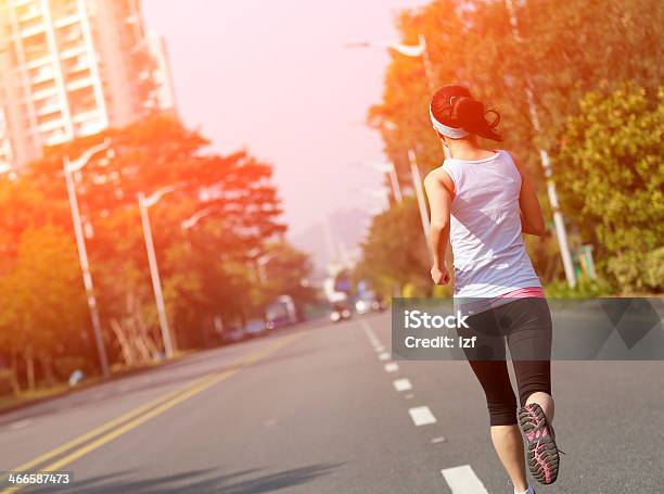 Fit Sports Woman Running At Asphalt Road Stock Photo - Download Image Now - Active Lifestyle, Activity, Adult