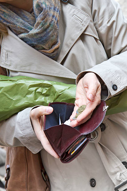 Woman counting money when shopping Woman counting money when shopping canadian coin stock pictures, royalty-free photos & images