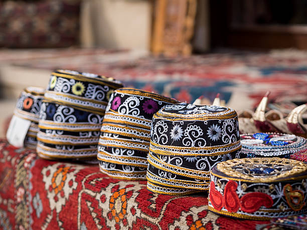 Taqiyah, traditional muslim hats placed on a typical carpet sold on a local market in Icheri Sheher (Old Town) in the Center of Baku, Azerbaijan, Caucasus. Horizontal orientation.