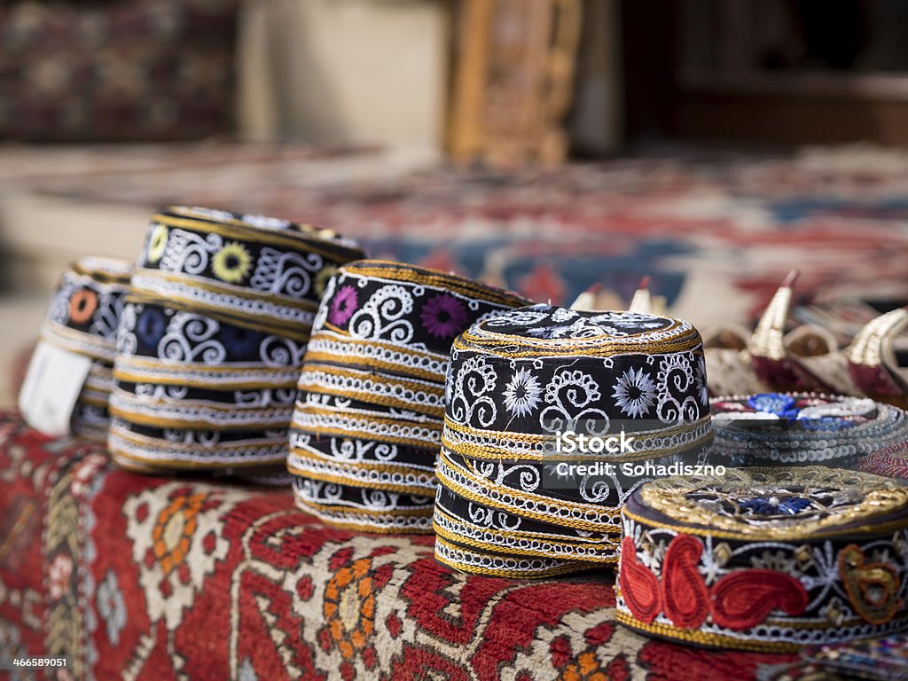 Group of stacked Azerbaijani hats laid out on table Taqiyah, traditional muslim hats placed on a typical carpet sold on a local market in Icheri Sheher (Old Town) in the Center of Baku, Azerbaijan, Caucasus. Horizontal orientation. Azerbaijan Stock Photo