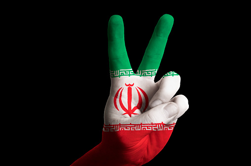 Hand with two finger up gesture in colored iran national flag as symbol of winning, victorious, excellent, - for tourism and touristic advertising, positive political, cultural, social management of country