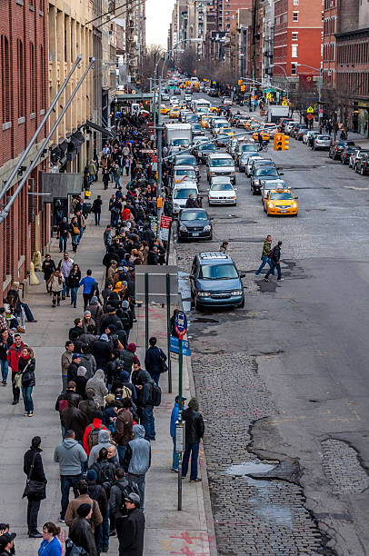 New York, USA - March 11, 2011: Line where hundreds of people were waiting in the street. This line was going all the way around the block and people were waiting so that they can get their hands in the new IPhone model released at that time.