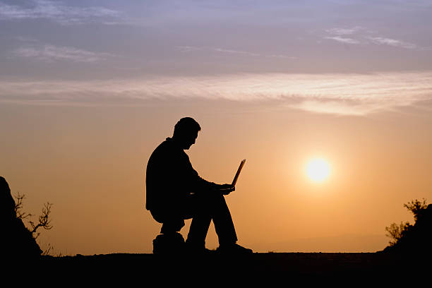 istock Silhouette of businessman working with laptop 466595165