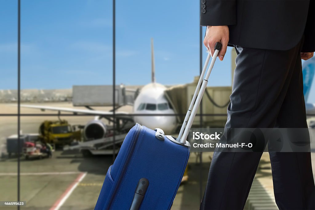 man walking travel bag business man walking travel bag by an international airport Business Travel Stock Photo