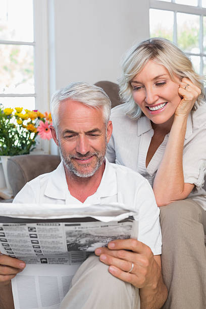 istock Mature couple reading newspaper 466596460