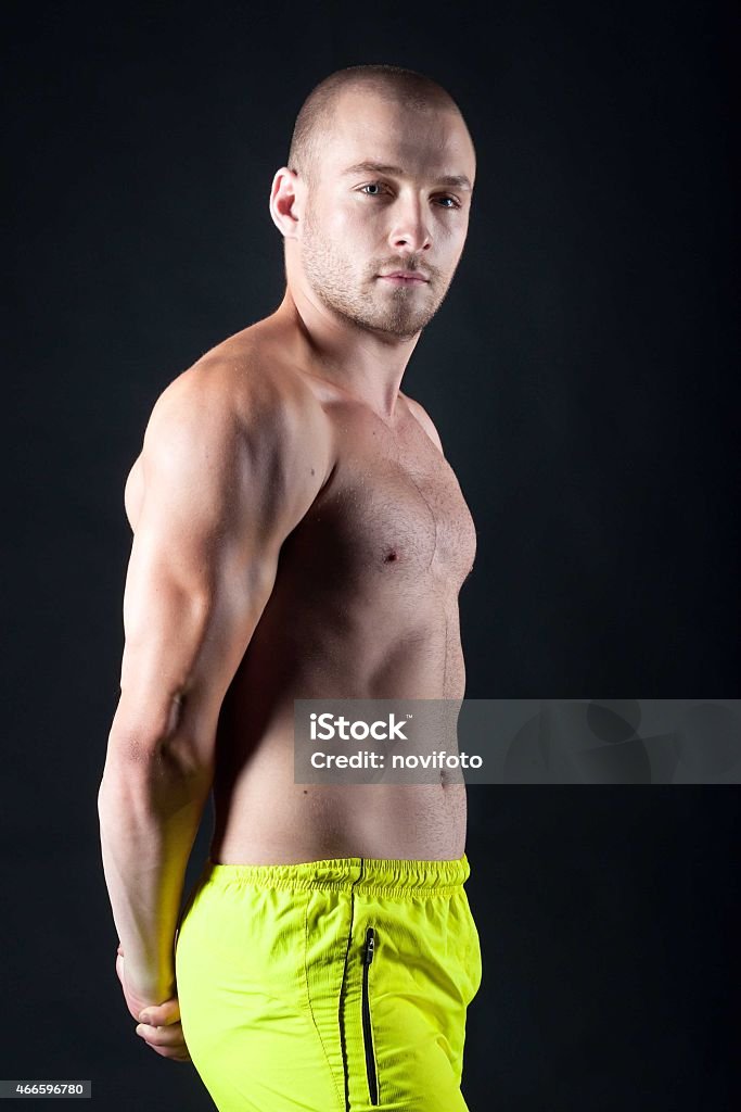 young male athlete Male athlete demonstrates triceps. 2015 Stock Photo