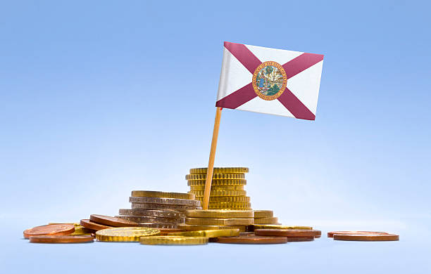 Flag of Florida in a stack of coins.(series) Flag of Florida in a mixed stack of european coins and a blue background.(series) support usa florida politics stock pictures, royalty-free photos & images