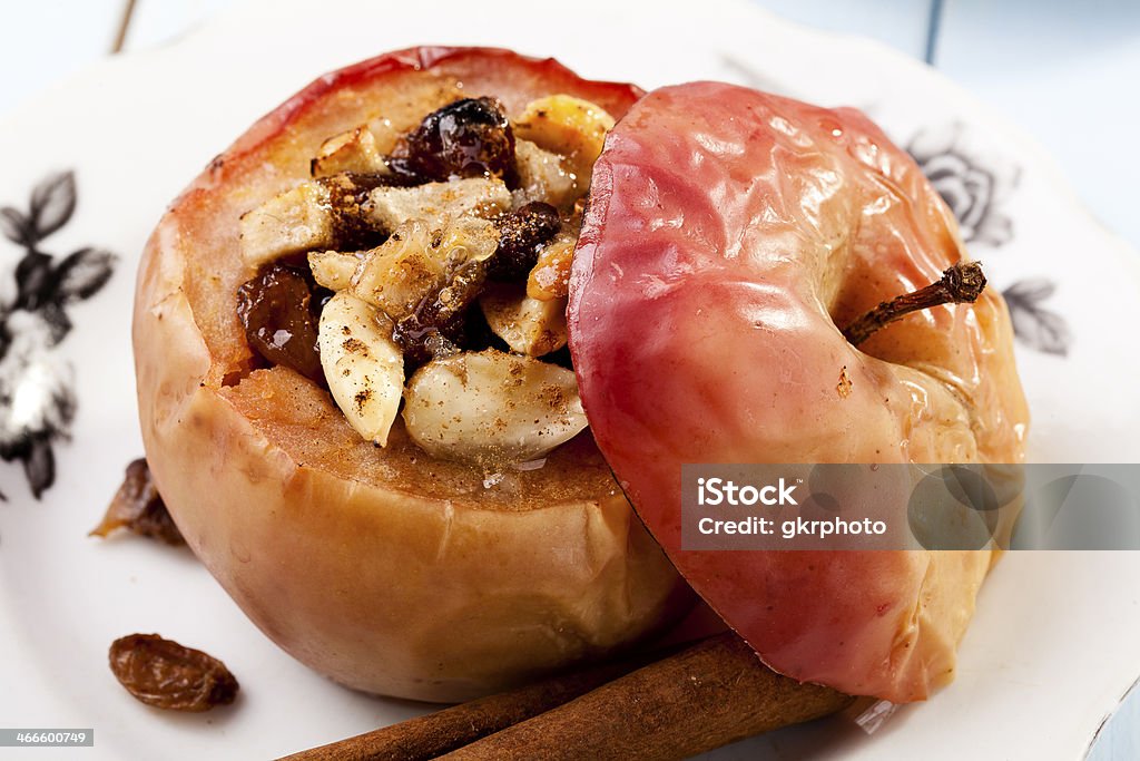 Baked apples with nuts and raisins Baked apples with nuts and raisins - focus on apple Baked Apple Stock Photo