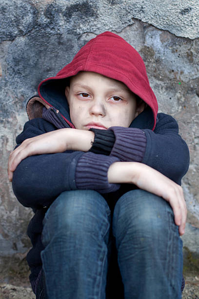 istock homeless boy leaned against the wall 466601635