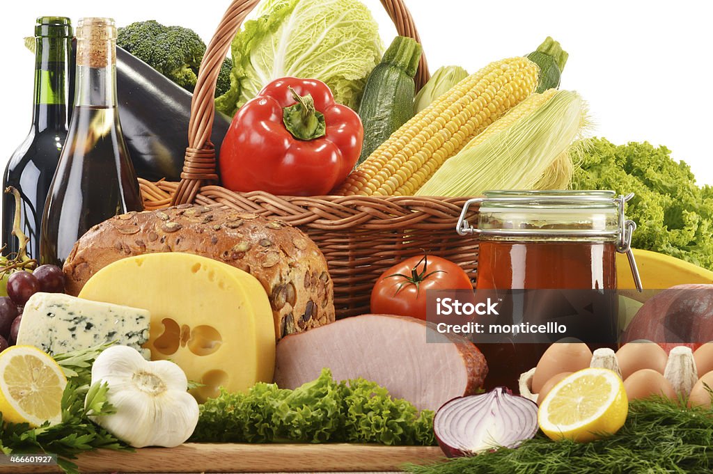 Composition with groceries in wicker basket on kitchen table Apple - Fruit Stock Photo