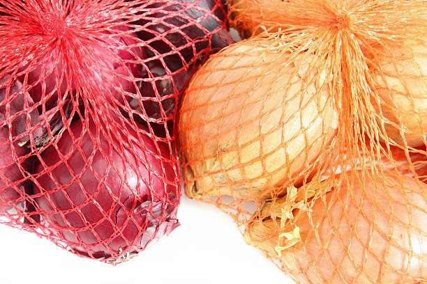 istock Image of red and white onions in string net onion-bags 466602560