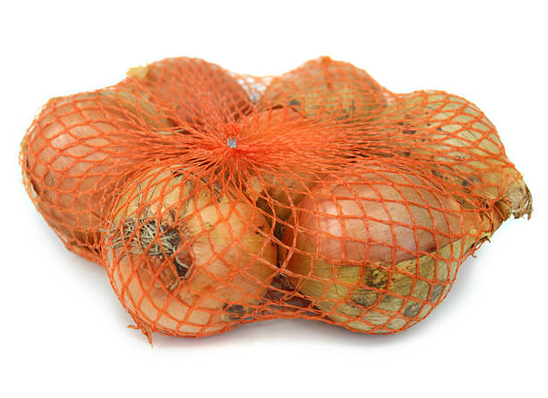 istock Image of dried white onions, white background, orange net bag 466602574