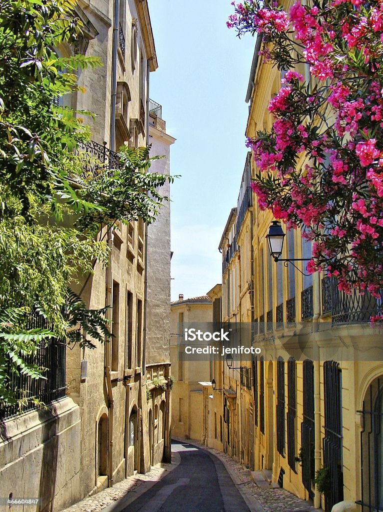 Flowers lining a narrow street in old Montpellier, France Montpellier Stock Photo