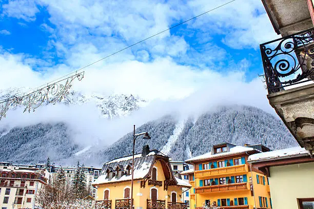 Chamonix town with snowy mountains on the background. Chamonix-Mont-Blanc was the site of the first Winter Olympics in 1924 and it's one of the oldest ski resorts in France.