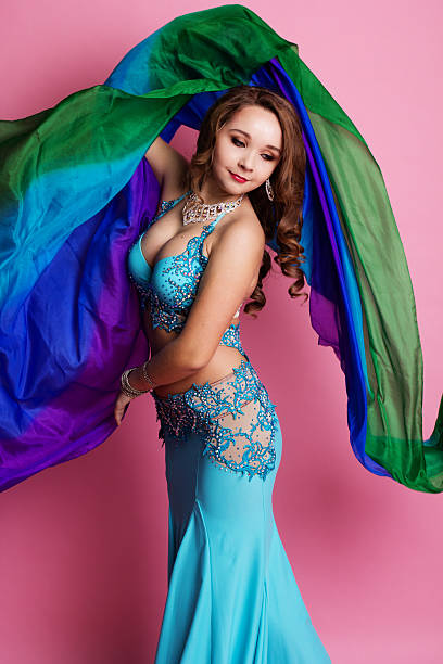 Beautiful belly dancer is wearing a blue costume stock photo