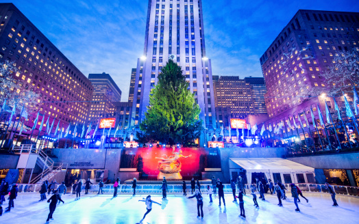 New York, United States - December 2, 2013: People ice skating at the rink under the traditional christmas tree at the Rockefeller Center, mid town manhattan.