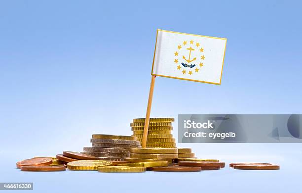 Flag Of Rhode Island In A Stack Of Coins Stock Photo - Download Image Now - 2015, American Culture, Assistance