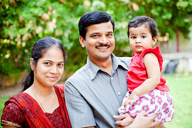 Young Cheerful Happy Indian Asian Family of three View more from this photo shoot... happy indian young family couple stock pictures, royalty-free photos & images