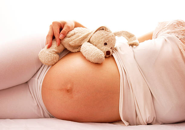 istock pregnant woman on a white background 466620371