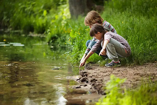 Photo of Boy with a girl near the water